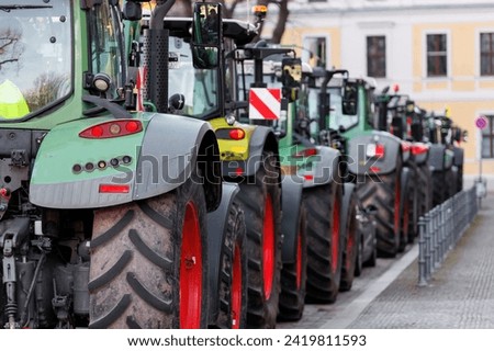 Farmers union protest strike against government Policy in Germany Europe. Tractors vehicles blocks city road traffic. Agriculture farm machines Magdeburg central Domplatz square Royalty-Free Stock Photo #2419811593