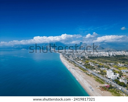 Stunning views of the beach, mountains and Konyaalti Park in Antalya, Turkey. A drone flies over the beach. Horizontal photo. Royalty-Free Stock Photo #2419817321