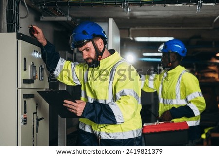 Engineers inspected the electrical switchboard and verified the operational voltage range.	Technician setting electrical in inverter solar panel room Royalty-Free Stock Photo #2419821379