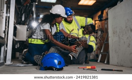 Team Engineers calls for assistance after a team member sustains a leg injury while doing electrical work. Technician in inverter solar panel room.