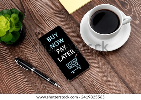 Buy now pay later shopping text on smart phone and cup of coffee Royalty-Free Stock Photo #2419825565