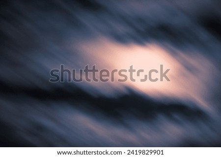 This is a long exposure of a Moon rise behind the cloud. 