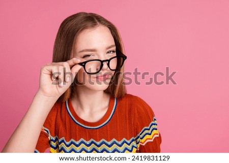 Photo of minded suspicious intelligent girl arm touch eyeglasses ponder empty space isolated on pink color background