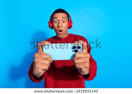 Photo of amazed excited man wear stylish red clothes play game competition omg wow win bet isolated on blue color background