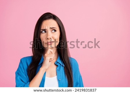 Photo of suspicious unsure girl with straight hairdo dressed blue shirt look empty space proposition isolated on pink color background Royalty-Free Stock Photo #2419831837