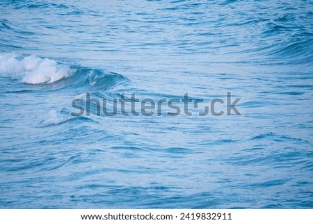 A picture of the sea with calm waves.