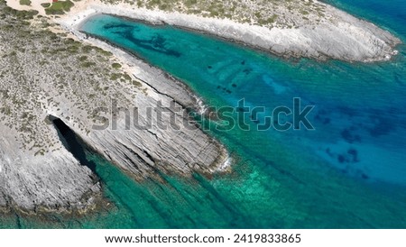 Aerial drone photo of beautiful paradise emerald beaches and volcanic cave formations visited by yachts and sailboats in Southern part of Antiparos island, Cyclades, Greece