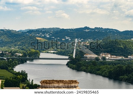 Scenery of Coimbra City in the summertime with the Mondego River and surrounding trees under a clear sky. Landscape background and wallpaper. Royalty-Free Stock Photo #2419835465