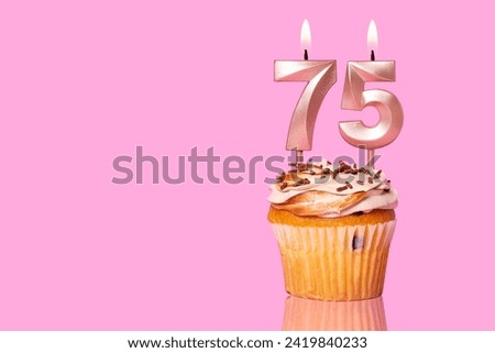 Birthday Cake With Candle Number 75 - On Pink Background.