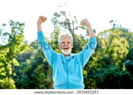 Smiling active senior man jogging exercising and having fun and celebrating success rasing hands taking a break in the park, concept of competition, winning, victory and strength Royalty-Free Stock Photo #2419855291