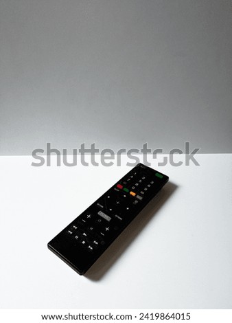 close-up black TV remote isolated on white background.