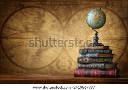 Old geographical globe and old book on map background. Science, education, travel background. History and geography team. Ancience, antique globe on the background of books. 
