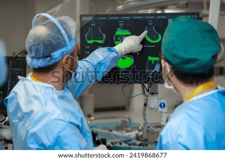 Team of doctor perform total hip arthroplasty replacement surgery in osteoarthritis patient inside the operating room. robot assisted robotic hip and knee replacement surgery	 Royalty-Free Stock Photo #2419868677