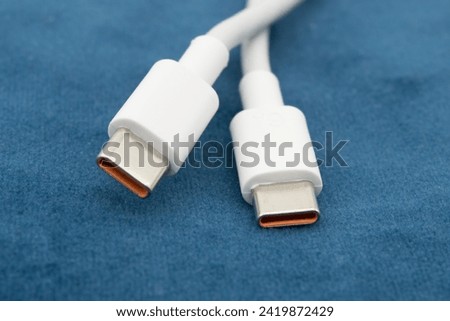 USB-C view of white USB-C plug on dark background.