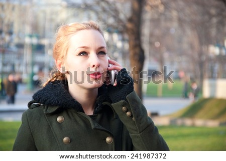 Young woman talking on mobile phone on the street