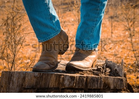feet of a woman wearing cowboy boots