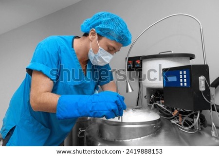 Embryologists a Liquid Nitrogen Bank Containing Sperm and Eggs Samples. ivf  in vitro fertilization, egg freezing. Sperm cryopreservation. Sperm freezing. Royalty-Free Stock Photo #2419888153