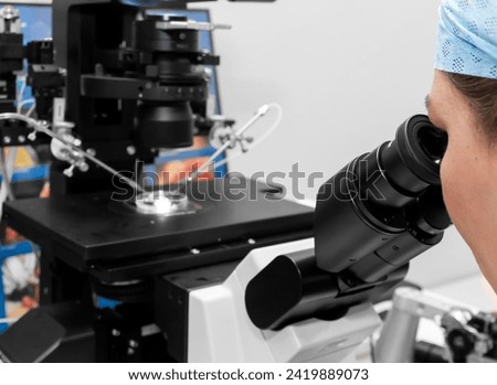 Embryologist adding sperm to egg in laboratory of reproductive clinic. in vitro fertilization, egg freezing. injects one sperm into each egg by microinjection. intracytoplasmic Sperm injection. IMSI Royalty-Free Stock Photo #2419889073