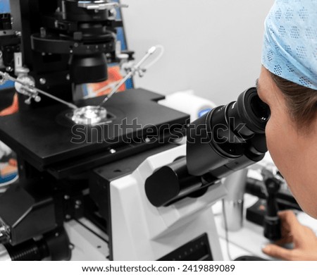 Embryologist adding sperm to egg in laboratory of reproductive clinic. in vitro fertilization, egg freezing. injects one sperm into each egg by microinjection. intracytoplasmic Sperm injection. IMSI Royalty-Free Stock Photo #2419889089