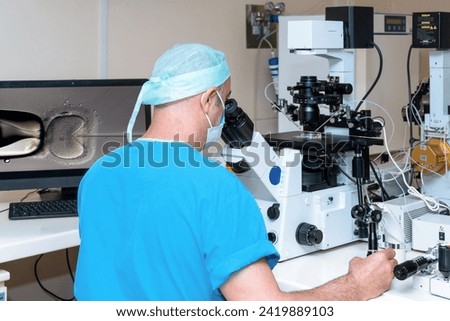 Embryologist adding sperm to egg in laboratory of reproductive clinic. in vitro fertilization, egg freezing. injects one sperm into each egg by microinjection. intracytoplasmic Sperm injection. IMSI Royalty-Free Stock Photo #2419889103