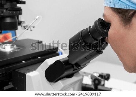 Embryologist adding sperm to egg in laboratory of reproductive clinic. in vitro fertilization, egg freezing. injects one sperm into each egg by microinjection. intracytoplasmic Sperm injection. IMSI Royalty-Free Stock Photo #2419889117