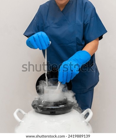 Embryologists a Liquid Nitrogen Bank Containing Sperm and Eggs Samples. ivf  in vitro fertilization, egg freezing. Sperm cryopreservation. Sperm freezing. Royalty-Free Stock Photo #2419889139
