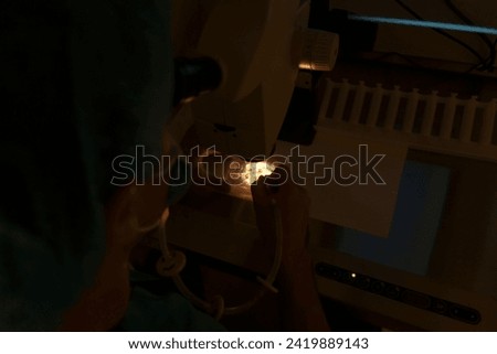 Embriologist putting sperm sample to examine under microscope or collecting in vitro cultured embryos for biopsy. Reproductive medicine clinic. Artificial insemination. Artificial conception clinic. Royalty-Free Stock Photo #2419889143