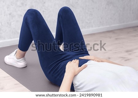 woman doing various sports moves - exercises for healthy life, pelvic floor exercise. Home sport workout. Elbows static balance stand. Floor stretching. Healthy lifestyle. Royalty-Free Stock Photo #2419890981