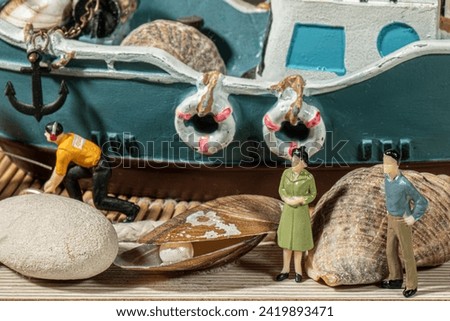 close-up detail miniature human figures lighthouse fishing boat designed with beach fishing concept hobby studio visual