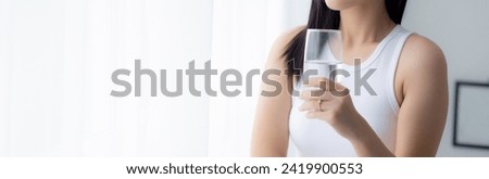 Beautiful young asian woman drinking glass of water mineral pure with fresh and happy at home, asia female drinking beverage for healthcare and weightloss, one person, lifestyles concept. Royalty-Free Stock Photo #2419900553