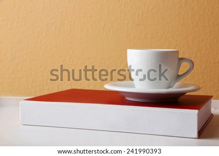 Civil Law book with cup on tabletop and light wall background