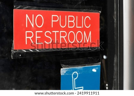 No Public Restroom sign posted on the door at a restaurant.