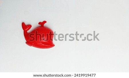 children's toy red whale on a white background