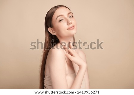 Beautiful young woman with clean fresh skin on beige background, Face care, Facial treatment, Cosmetology, beauty and spa, women portrait.