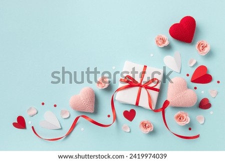 Gift or present box for Saint Valentine or Mother day decorated with pink red hearts and roses flowers top view. Flat lay festive greeting card.
 Royalty-Free Stock Photo #2419974039