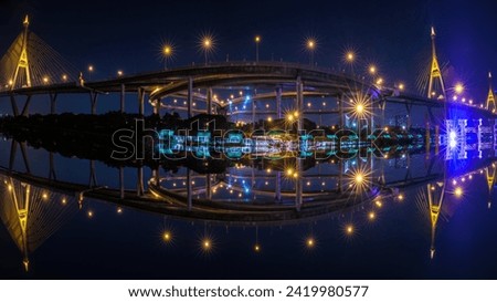 Night scene shot and over starlight effect, Bhumibol bridge and reflection of water. bangkok thailand, wide angle cityscape at night transport concept,