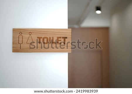 Toilet wooden sign for male and women toilet on white wall background. Copy space
