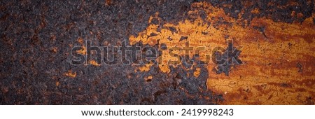 Texture of rusty metal. Rough metal surface with rust. Corroded and oxidized old iron. Rusted and aged metal sheet. Wide panoramic texture for background and design in grunge style. Royalty-Free Stock Photo #2419998243