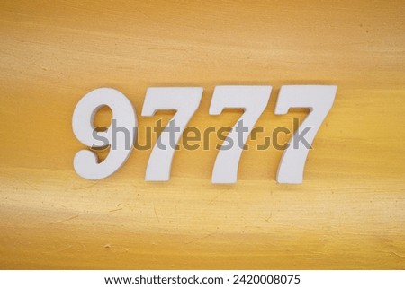 Gold background, numbers 9777 spray painted white.