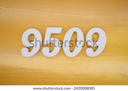 Gold background, numbers 9509 spray painted white.
