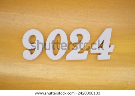 Gold background, numbers 9024 spray painted white.