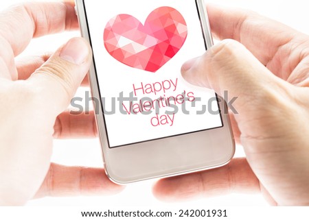 Two hand holding smart phone with pink polygon heart shape and Happy Valentine's day on screen, Love concept.