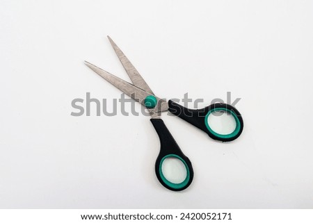 Open scissors on a white background 