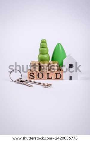 The inscription Sold made of wooden cubes on a plain background. Can be used for your design