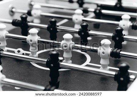 table football, board game for children and adults, entertainment events for celebrating weekends and holidays, black and white figurines and soccer ball