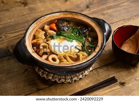 Udon noodles cooked in a small pot