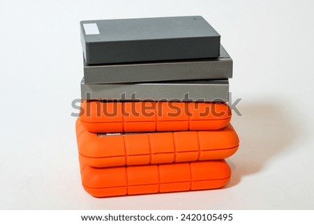 A stack of hard drives or hard disc drives on a white background. Data storage devices in a pile. Closer-up Royalty-Free Stock Photo #2420105495