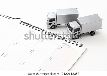 Calendar and toy truck on a white background.