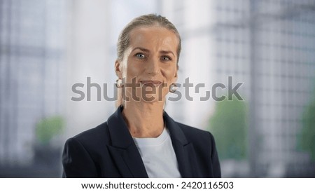 Close-Up Portrait of a Beautiful Businesswoman Wearing a Suit, Posing for Camera. Successful Female Politician Smiling, Looking at Camera. Professional Congresswoman Feeling Inspired and Empowered