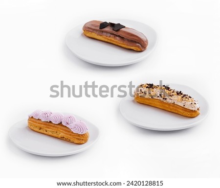 different eclairs with cream and chocolate on plate Royalty-Free Stock Photo #2420128815